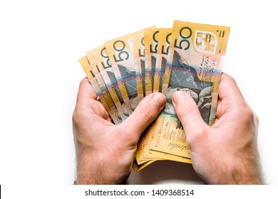 Businessman hands counting fifty Australian Dollar bills isolated on white background. Male hands holding Australian money banknotes in concept of currency exchange and payment. Money concept. 