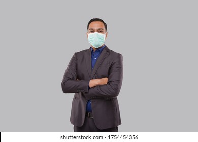 Businessman Hands Crossed Wearing Medical Mask Isolated. Indian Businessman Standing - Powered by Shutterstock