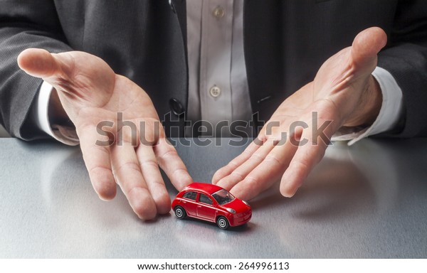 businessman hands\
displaying car at the\
office