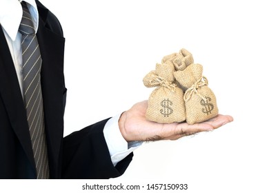 Businessman hands hold a money bags on white background give for loans to planned business investment in the future concept.