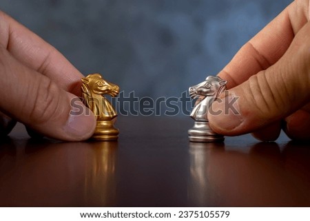 Businessman hands holding horses face to face for business battle. Business leaders and confrontation solving chess board game concept with copy space for your text. 