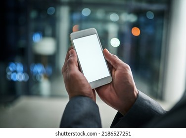 Businessman Hands Holding Phone With White Screen Template In Modern Office. Closeup Businessperson Reading Text Message On Smartphone At Night While Working Overtime At Work