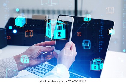 Businessman hands holding smartphone, laptop on desk. Digital cybersecurity hologram with blockchain, floating blocks and padlock with binary. Concept of device unlock