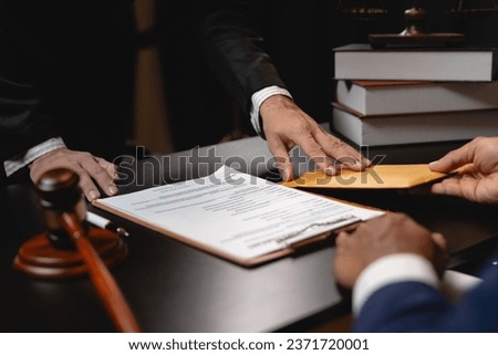 Businessman hands money envelope to lawyer in bribe over illegal business contract documents Investing, accepting bribes, corruption, fraud, unfairness, violation of ethics.
