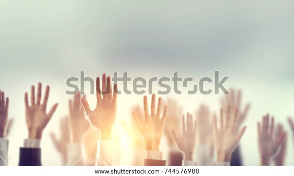 Businessman Hands raising for Participation with\
sunlight, Silhouette, copy\
space.