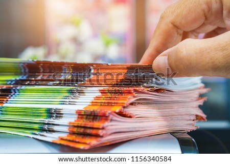 Businessman hands searching Stack of Brochure report paper documents for business desk, Business papers for Annual Report files, Business offices concept, soft focus