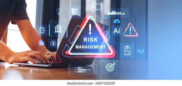Businessman hands typing on laptop, virtual screen with risk management icon and glowing diverse banking or marketing symbols. Concept of business safety and investment