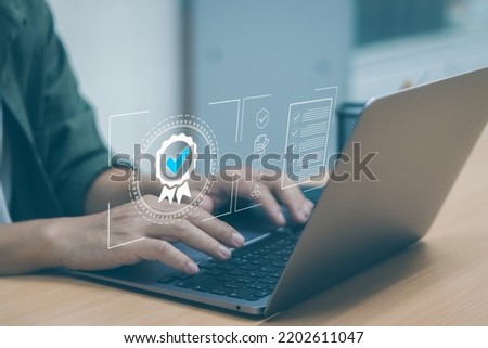 Businessman hands typing on laptop keyboard showing quality assurance with icons. concept Certification(ISO) Warranty guarantee of customer satisfaction and confidence in  quality product or service.