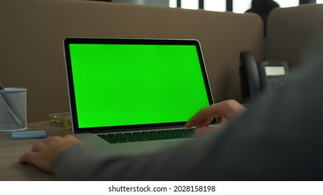 Businessman hands using laptop green screen in office. Unrecognizable professional working on computer green screen. Closeup man fingers scrolling trackpad on laptop chroma key at workplace - Powered by Shutterstock