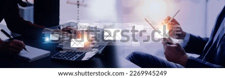 Businessman hands using Laptop typing on keyboard and surfing the internet on office table with email icon, email marketing concept, send e-mail or news letter, online working internet network.