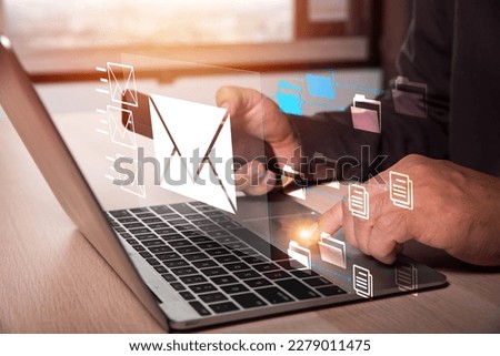 Businessman hands using Laptop typing on keyboard and surfing the internet on office table with email icon, email marketing concept, send e-mail or news letter, online working internet network