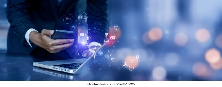 Businessman hands using smartphone with laptop computer and digital technology network connection, Business marketing concept. - Shutterstock ID 2168515405