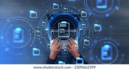 Businessman hands working with laptop, top view double exposure with online documentation system and business files storage. Concept of electronic documents and data storage