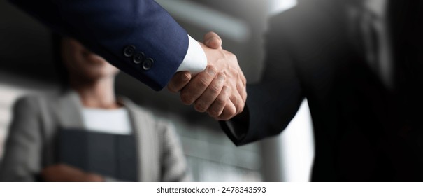 Businessman handshake for teamwork of business merger and acquisition,successful negotiate,hand shake,two businessman shake hand with partner to celebration partnership and business deal concept - Powered by Shutterstock