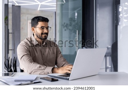 Businessman happy successful and smiling working with laptop inside office at workplace, man satisfied with financial result prepares report, accountant financier typing on computer keyboard.
