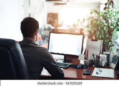 Businessman hard at work on a computer in an office