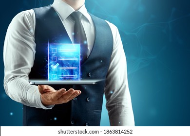 The Businessman Has A Blue Hologram Of The Contract In The Palm Of His Hand. Concept Of Electronic Document Circulation, Electronic Signature, Online Cooperation. Mixed Environment