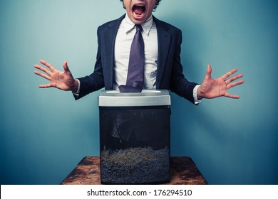 Businessman Has Got His Tie Stuck In A Paper Shredder