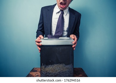 Businessman Has Got His Tie Stuck In A Paper Shredder