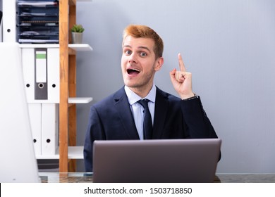 Businessman Having Ah Ha Moment While Working In Office On Laptop