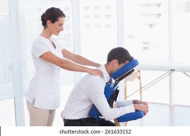 Businessman having back massage in medical office