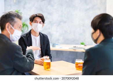 Businessman having a drink with mask on - Powered by Shutterstock