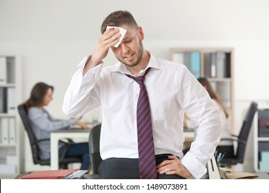 Businessman having panic attack in office