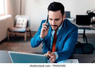 Businessman Having Phonecall In Modern Office.