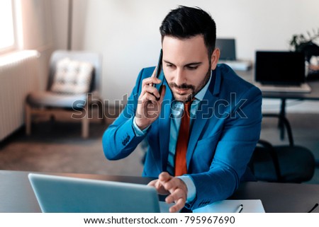 Businessman having phonecall in modern office.
