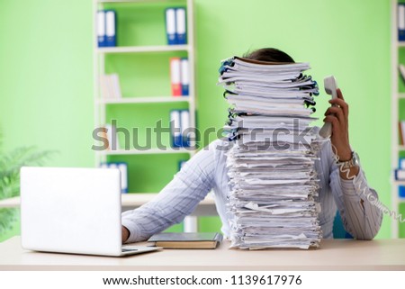 Businessman having problems with paperwork and workload