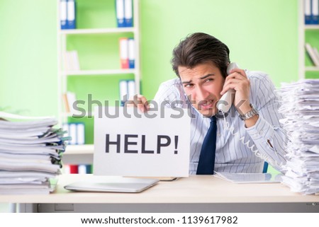 Businessman having problems with paperwork and workload