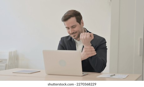 Businessman having Wrist Pain while using Laptop - Shutterstock ID 2270368229
