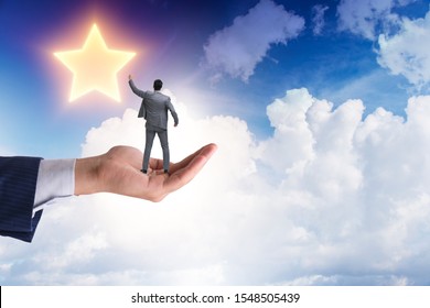 Businessman Held On Hand Reaching Out For Stars