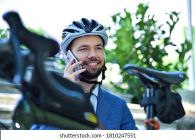 Businessman in helmet sitting on stairs and talking on mobile phone with bicycle. Business Business and urban style concept - Powered by Shutterstock