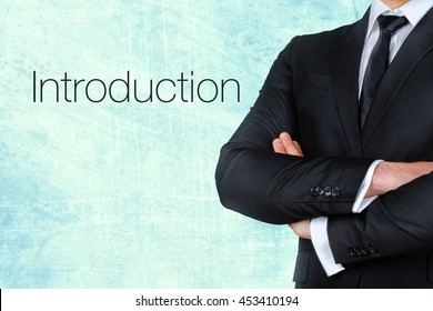 A Businessman With His Arms Crossed Near Text - Introduction