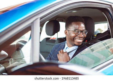 Businessman In His Car Fastening The Seatbelt, Safe Driving Concept. Car Safety. Business Man Fastening Seat Belt In Auto, Driving To Work, Copy Space. Man Wearing Seat Belt In Car Before Driving 