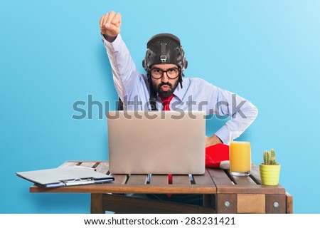 Businessman in his office with pilot hat over colorful background
