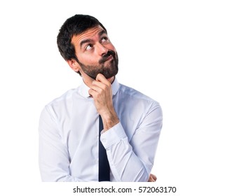 Businessman in his office thinking - Shutterstock ID 572063170