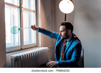 Businessman Hitting A Fly With Fly Swatter.