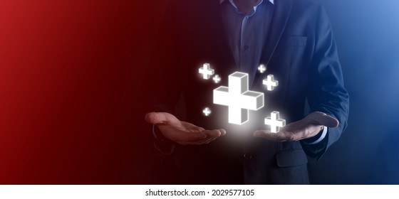 Businessman hold 3D plus icon, man hold in hand offer positive thing such as profit, benefits, development, CSR represented by plus sign.The hand shows the plus sign. - Shutterstock ID 2029577105