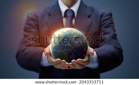 Businessman hold Global World. Planet Earth in hand of business man show Global warming, Save Environment, Earth day, Worldwide network, internet, Business world concept. Earth image provided by Nasa.