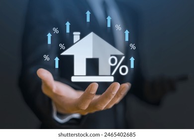 Businessman hold house with percentage, concept of real estate market trends, mortgage rates, property investment and housing market analysis, interest rates and financial planning, home ownership