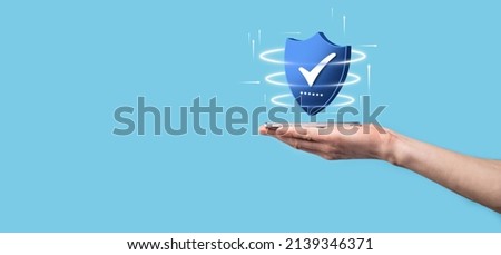 Businessman hold low poly polygon shield with a tick icon.Secure Access System Concept.Business Financial Warranty for Investment.antivirus concept.Technology security.Protection network,safe data