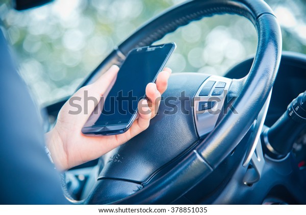 businessman and hold phone in car, man\
using phone while driving the car, vintage color\
tone