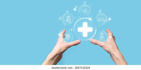 Businessman hold virtual plus medical network connection icons. Covid-19 pandemic develop people awareness and spread attention on their healthcare.Doctor,document,medicine,ambulance,patient icon - Shutterstock ID 2057132324