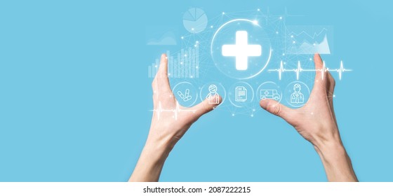 Businessman hold virtual plus medical network connection icons. Covid-19 pandemic develop people awareness and spread attention on their healthcare.Doctor,document,medicine,ambulance,patient icon - Shutterstock ID 2087222215