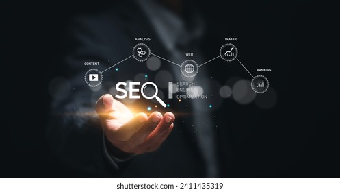 Businessman hold virtual SEO icon to analyze SEO search engine optimization for promoting ranking traffic on website and optimizing your website to rank in search engines. - Powered by Shutterstock