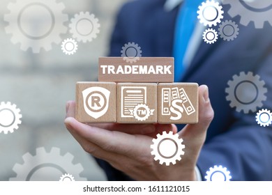 Businessman hold wooden blocks with trademark business concept. Trade Mark TM Brand Copyright Patent.