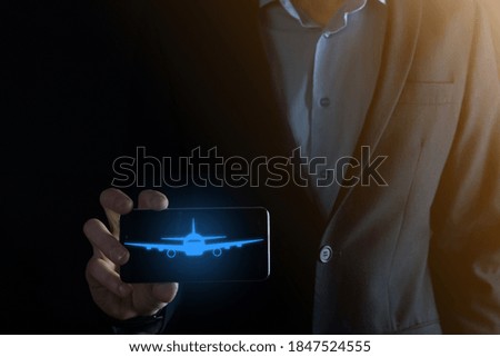 Businessman holding an airplane icon in his hands. Online ticket purchase.Travel.