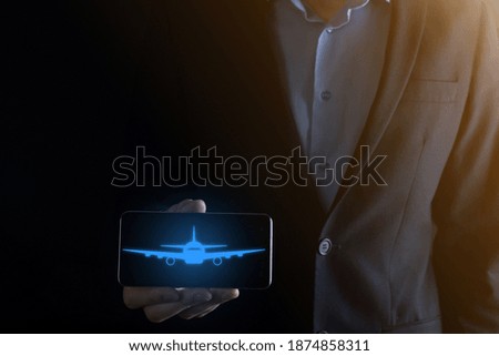 Businessman holding an airplane icon in his hands. Online ticket purchase.Travel.